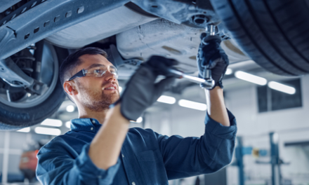mechanic works on car AutoZone stock AZO
