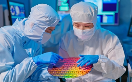 two workers make semiconductor wafer Taiwan Semiconductor stock TSM stock