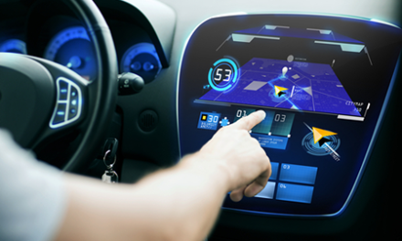 hand searching for route using navigation system on car dashboard screen