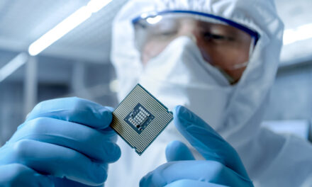 person holds semiconductor in hand Amkor stock semiconductor stock AMKR stock Micron stock MU stock
