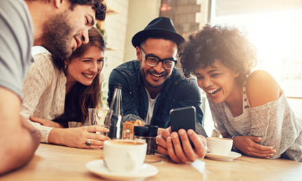group of people look at cell phones