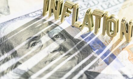 Inflation block letter casting shadow on $100 bill